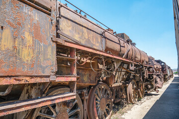 Steam locomotive in very bad condition, completely rusty and abandoned on the unused tracks at...