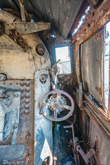 Steam locomotive in very bad condition, completely rusty and abandoned on the unused tracks at...