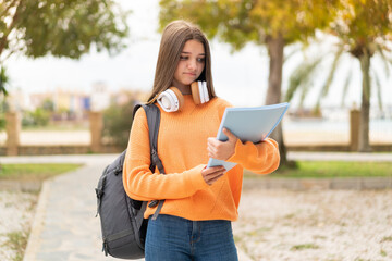 Obraz premium Young student girl over isolated background with sad expression