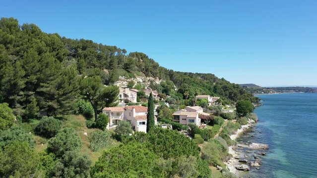 Aerial view drone video flying from the air over the picturesque sea coast of the south of France, Provence, Istres at bright sunny summer day