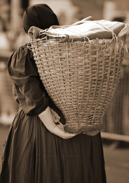 Elderly female of Italian partisan group called PORTATRICI CARNICHE carrying a wicker basket called GERLA
