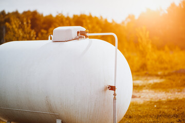 Rural home with large white propane gas tank