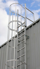 Industrial iron safety cage ladder for rooftop access to prevent falls