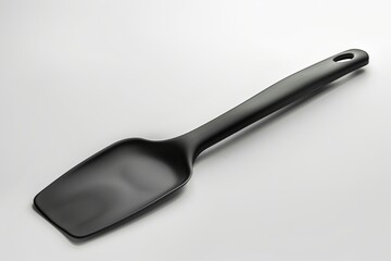 Fototapeta premium High-quality black kitchen spatula isolated on a clean background. Minimalist design for cooking and baking. Sleek and functional kitchen tool. Perfect for modern kitchens. Generative AI