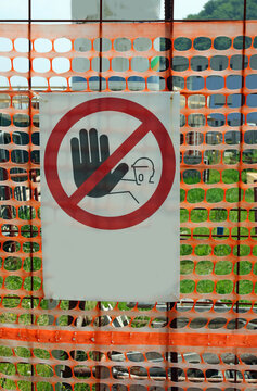 site sign without text warning unauthorized personnel to stay out and orange protective netting