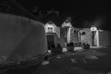 Famous traditional old dry stone trulli houses with conical roofs in Alberobello, Italy.