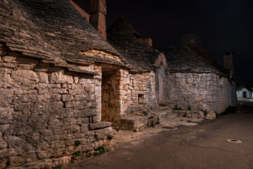 Famous traditional old dry stone trulli houses with conical roofs in Alberobello, Italy.