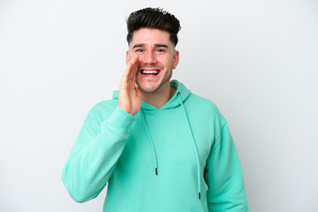 Young caucasian man isolated on white background shouting with mouth wide open
