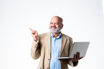 portrait of senior old Indian asian businessman using laptop against white background