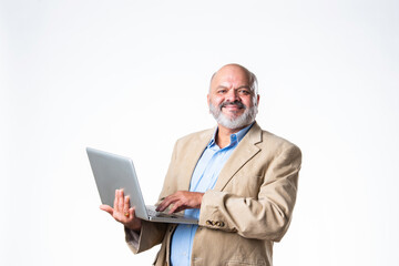 portrait of senior old Indian asian businessman using laptop against white background