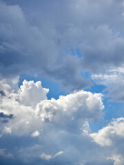 Cumulus clouds. White clouds on the blue sky close-up.
