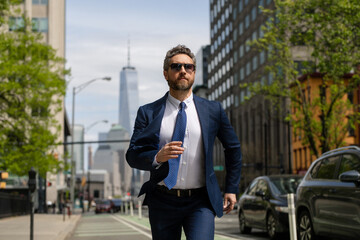 Business man in suit run in NY. American business. Businessman run down street, late for a meeting. Businessman in suit run be success. Running business man. Fast business. Run and late businessman.