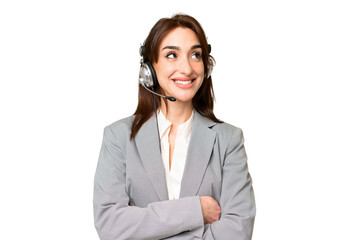 Telemarketer caucasian woman working with a headset over isolated chroma key background looking up while smiling