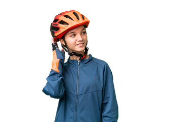 Teenager cyclist girl over isolated chroma key background thinking an idea