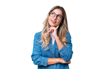 Young Uruguayan woman over isolated background looking up while smiling