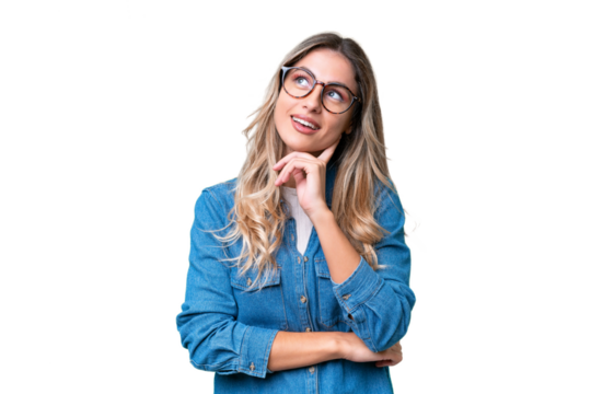 Young Uruguayan woman over isolated background looking up while smiling