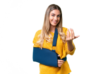Young Uruguayan woman with broken arm and wearing a sling over isolated background inviting to come with hand. Happy that you came