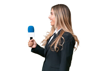 Young pretty Uruguayan tv presenter over isolated background laughing in lateral position