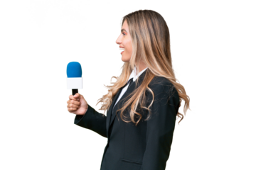 Young pretty Uruguayan tv presenter over isolated background laughing in lateral position