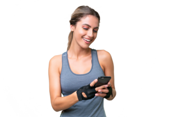 pretty Sport Uruguayan woman over isolated background sending a message with the mobile