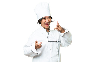 Young chef Argentinian woman over isolated background pointing to the front and smiling