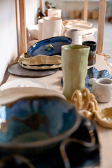 Products baked clay of various shapes stand on shelf....