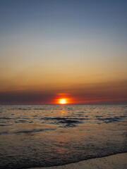 Obraz premium Sunset sea vertical view landscape horizon beautiful summer season shore nobody wind wave cool holiday look calm big sunset sky twilight evening day time nature tropical coast ocean water travel