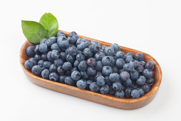  A shrub of the azalea family. The fruit is light blue or black in color and has white powder on the outside.
