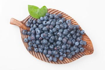  A shrub of the azalea family. The fruit is light blue or black in color and has white powder on the outside.
