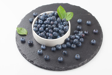  A shrub of the azalea family. The fruit is light blue or black in color and has white powder on the outside.
