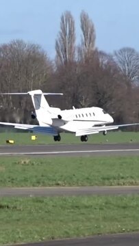 Business jet Landing with Touch Down at Airport (Corporate Executive Private Jet Touching down at Airfield)