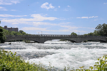 Pedestrian bridge to Goat Island, Niagara Falls, New York.  Rapids on the Niagara river. View from Prospect Point. Niagara Falls State Park.