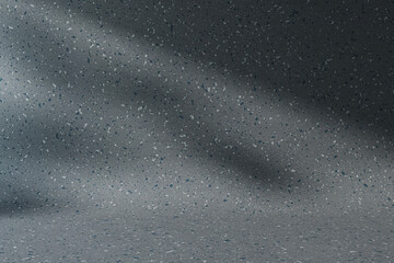 An empty studio room with a textured dark grey background showing scattered white speckles, ideal for product presentation. 3D Rendering