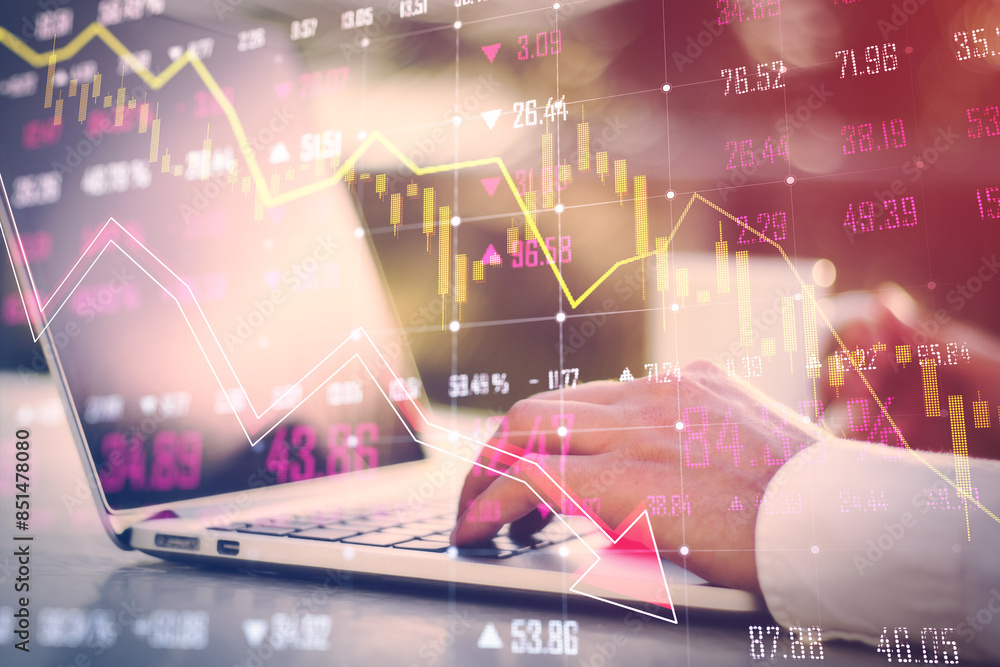 Poster a double exposure image showing hands typing on a laptop with financial charts overlay, representing