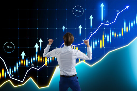 A man in business attire celebrates success in front of a virtual stock market graph on a digital background, symbolizing financial achievement