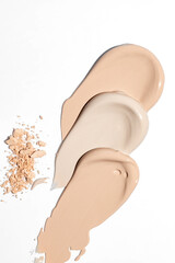 beautiful liquid foundation strokes and Make up crushed powder on white background. Texture of make up crushed powder