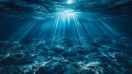 A deep blue ocean with light shining down, viewed from the bottom of an underwater scene. The water is calm and serene, creating a sense of tranquility and vastness in its depth.