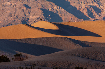 Sunset near the flat sand dunes in Death Valley National Park, California.