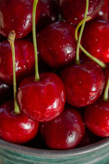 Fresh cherries straight from the garden, in green dishes, a healthy eating concept