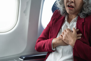 Mature with chest pain with nausea feeling sick while sitting in the airplane , Passengers near the...