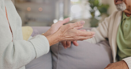 Hands, lounge and senior couple, talking and closeup in house, discussion and communication with partner. Living room, sofa and speaking of mature people, conversation and divorce in apartment