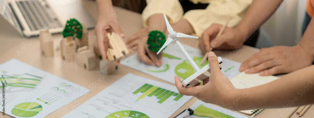 Poster windmill model represented using renewable energy placed during presenting green business on table w