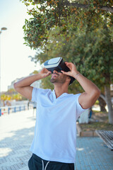 Fototapeta premium Man experiencing virtual reality on a sunny day in the city