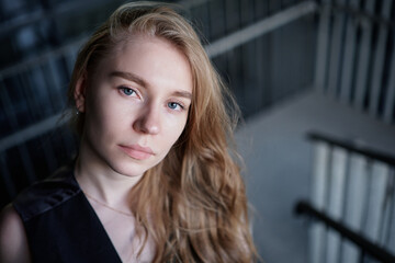 Portrait of a attractive young positive adult female on the business background. Student, business woman, services. High quality photo