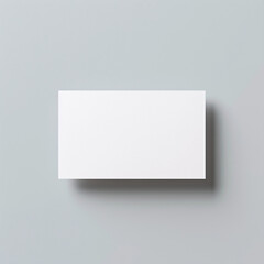 a mockup of a blank white business card, view from top, grey background, minimalism, copy space