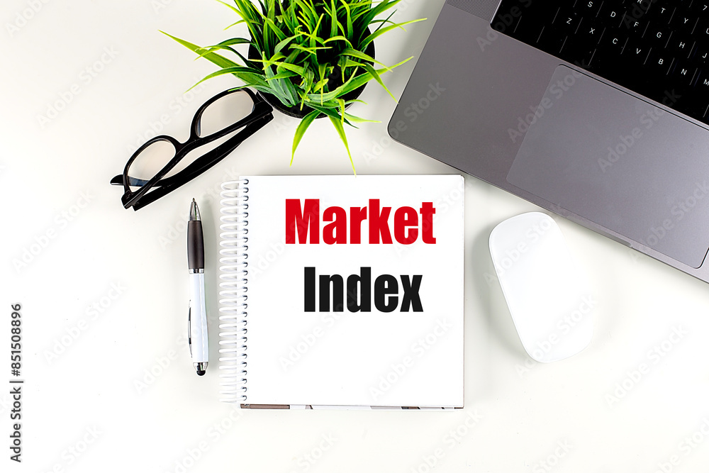 Poster market index text on notebook with laptop, mouse and pen