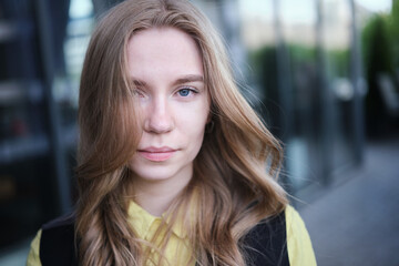 Obraz premium Portrait of a attractive young positive adult female on the business background. Student, business woman, services. High quality photo