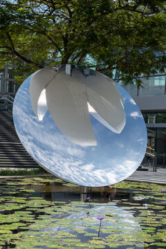 Singapore - 9 March 2024: Sky Mirror, a sculpture by Anish Kapoor in front of ArtSceince Museum, a museum within the Marina Bay Sands in the Downtown Core of the Central Area in Singapore