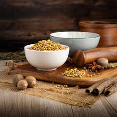 CORIANDER SEEDS on wooden table background. Herbs, spices and dried food baking ingredient. Mortar and different spices. Cottage kitchen. Product Photography