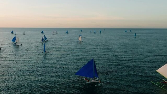 Blue sea with paraw sailing boats. Sunset viewing in Boracay, Philippines.